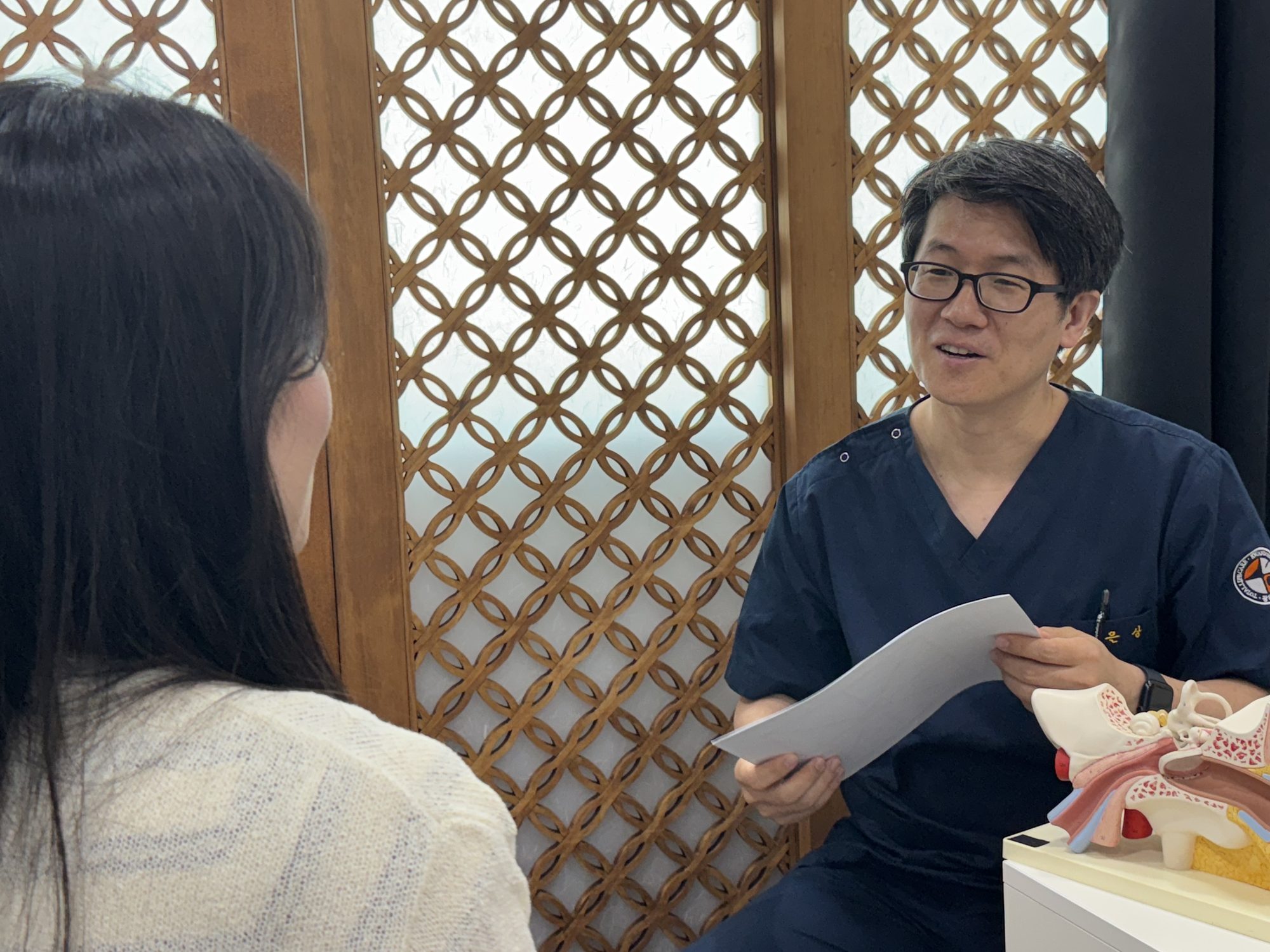 Dizziness clinic doctor explaining with an inner-ear model