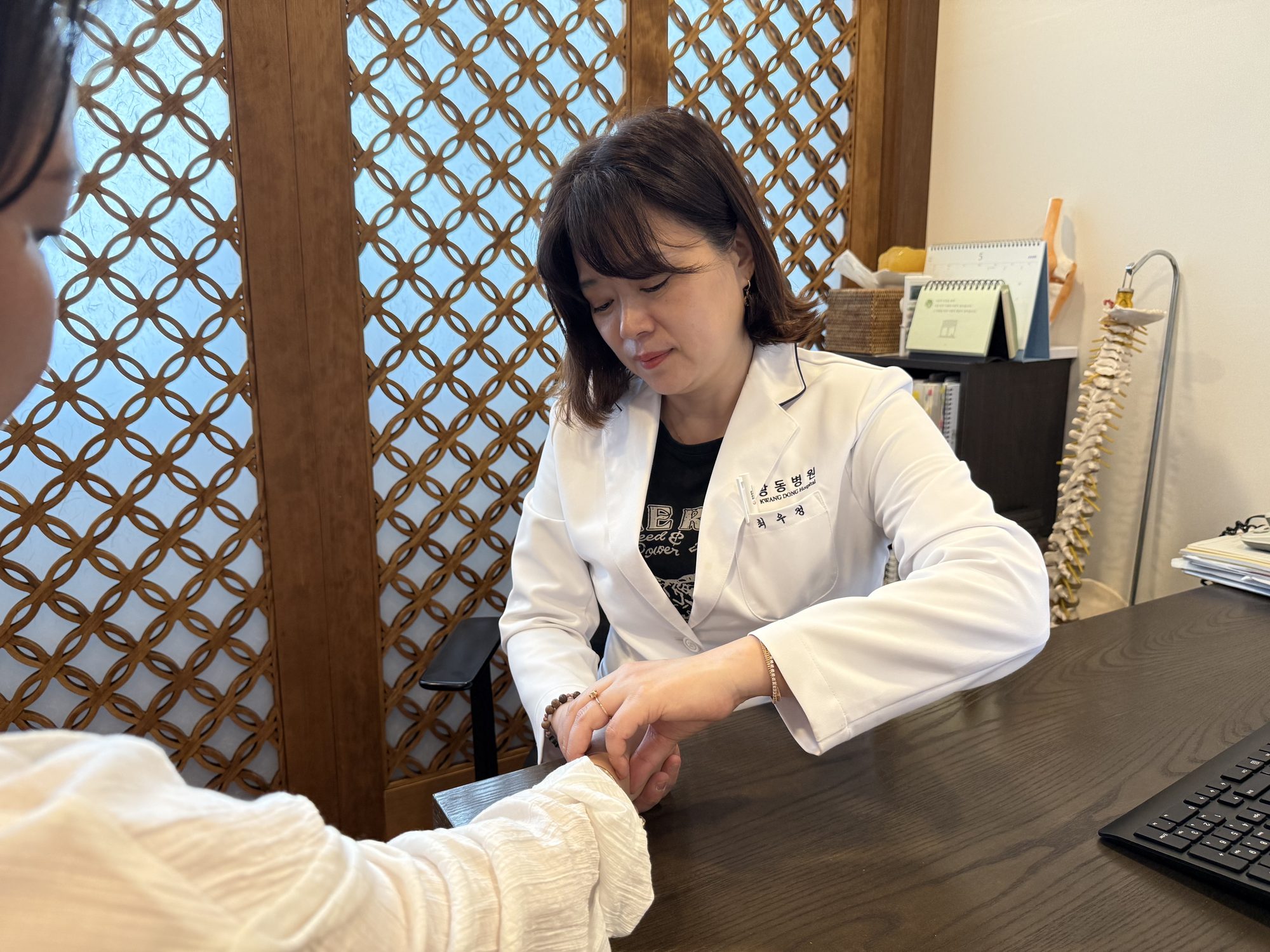 Korean medicine doctor taking a pulse reading